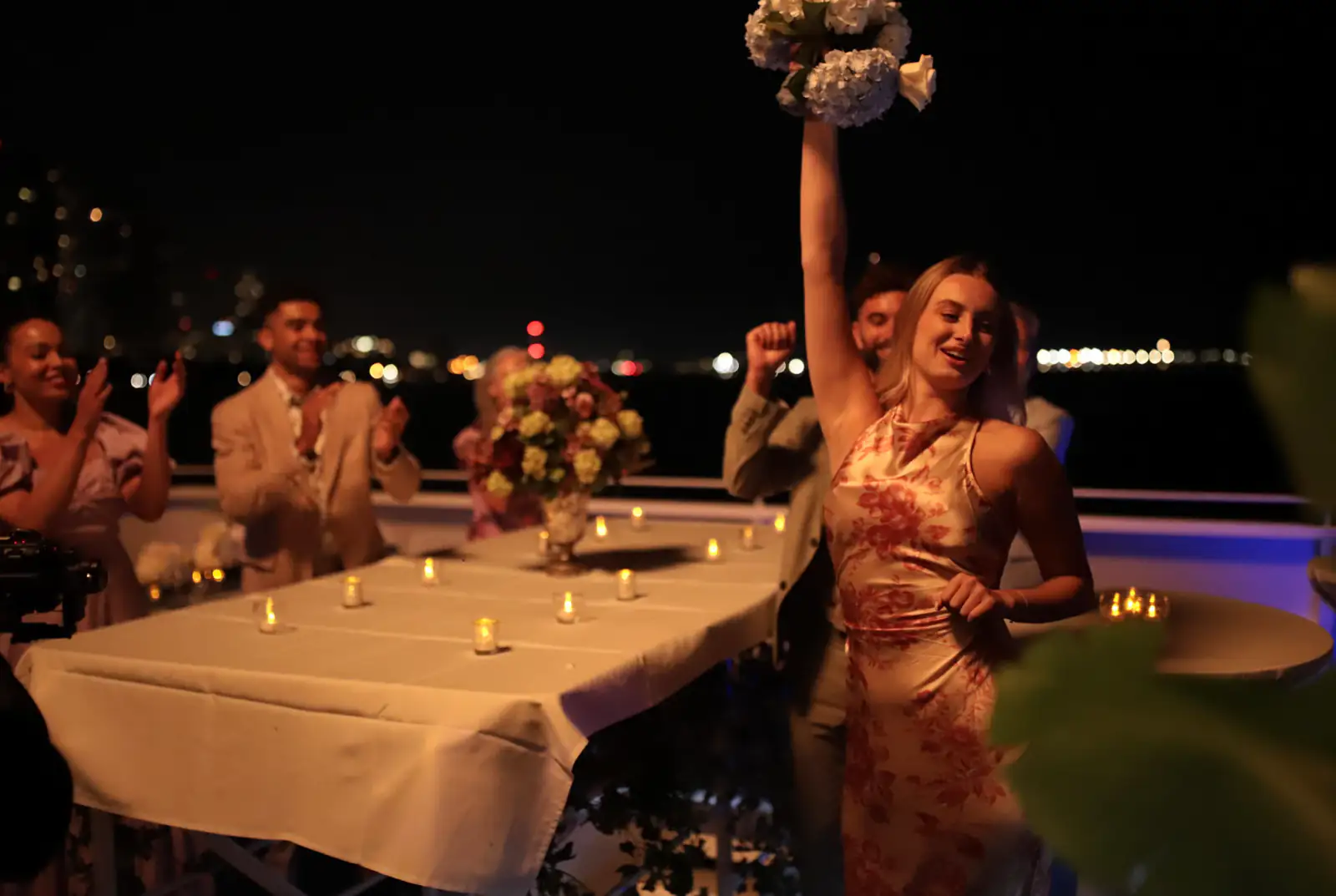 Guests celebrating on the deck of Yankee Lady at night